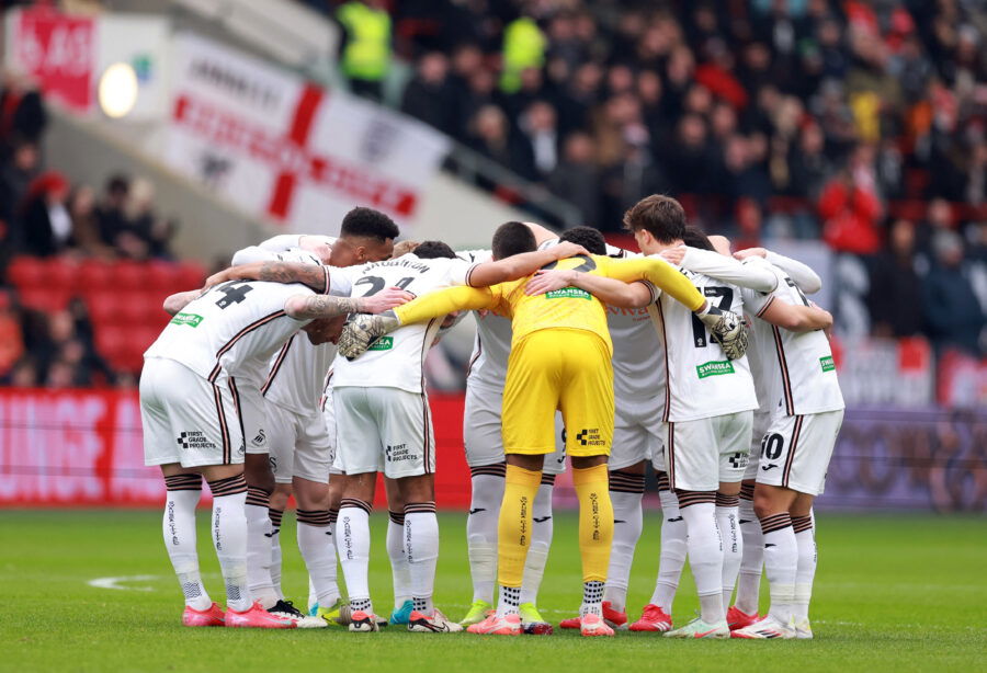 Swansea City players huddle