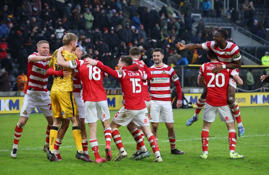 Doncaster Rovers' Teddy Sharman-Lowe with teammates celebrate after winning the penalty shoot-out