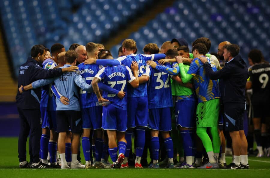 Sheffield Wednesday players huddle before the penalty shootout